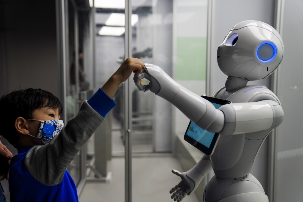 A child interacts with a robot at an exhibition “Robots – The 500-Year Quest to Make Machines Human” at the Science Museum in Tsim Sha Tsui on November 16, 2020. Photo: Sam Tsang