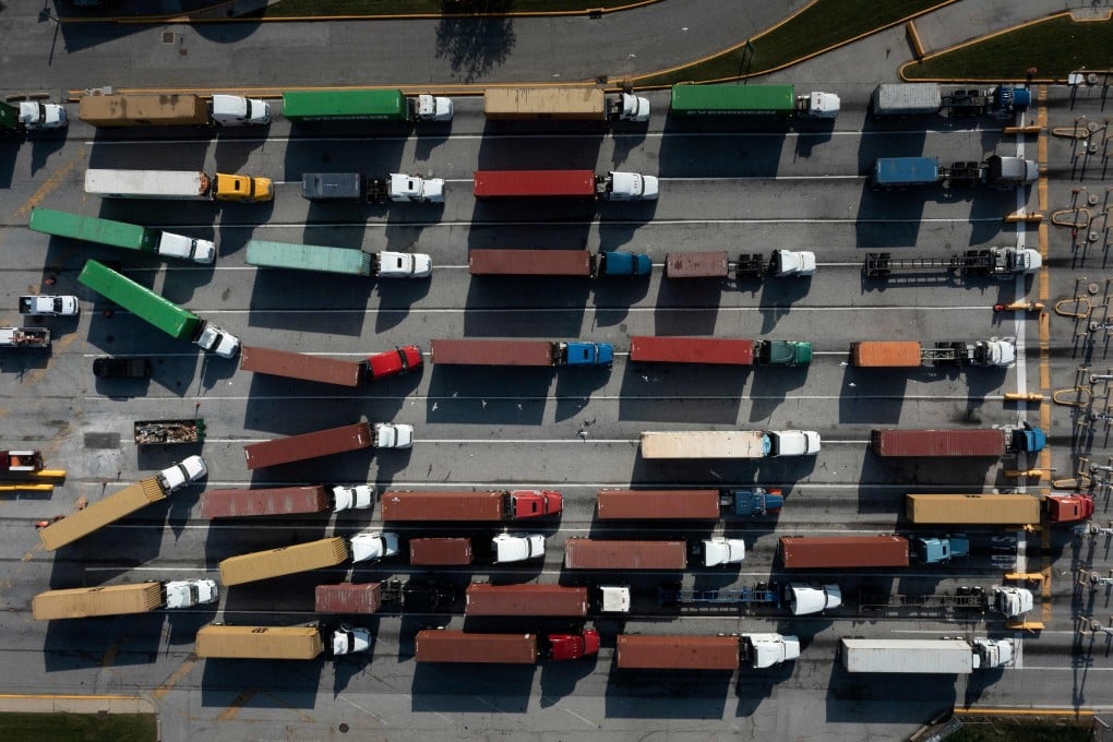 Trucks transport cargo containers at the Port of Baltimore in Maryland. Supply bottlenecks have contributed to a sharp rise in prices. But these pressures are not demand-driven and are likely to fade before they become embedded in long-term inflation expectations. Photo: AFP