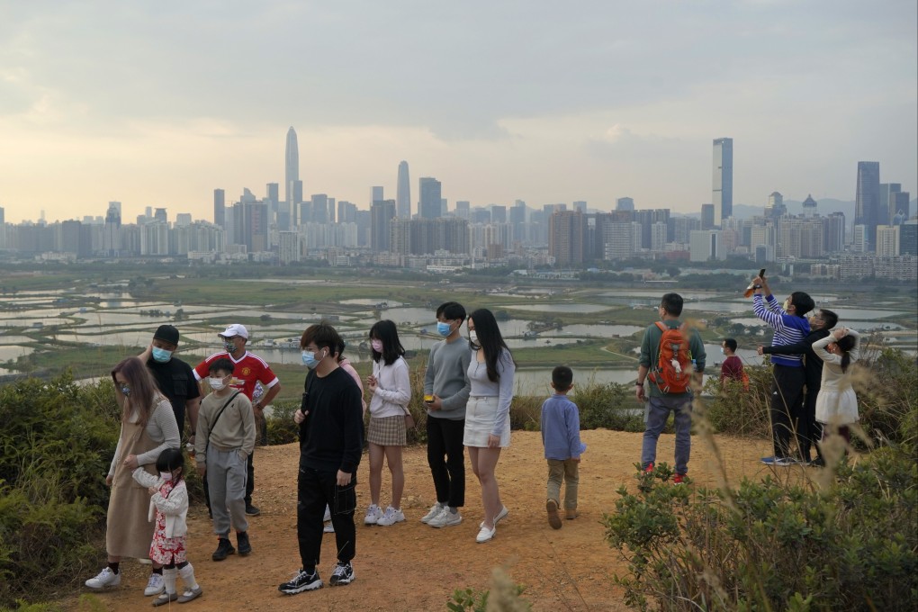 People visit the border of Hong Kong on February 13, with the Shenzhen skyline in the background. Photo: AP