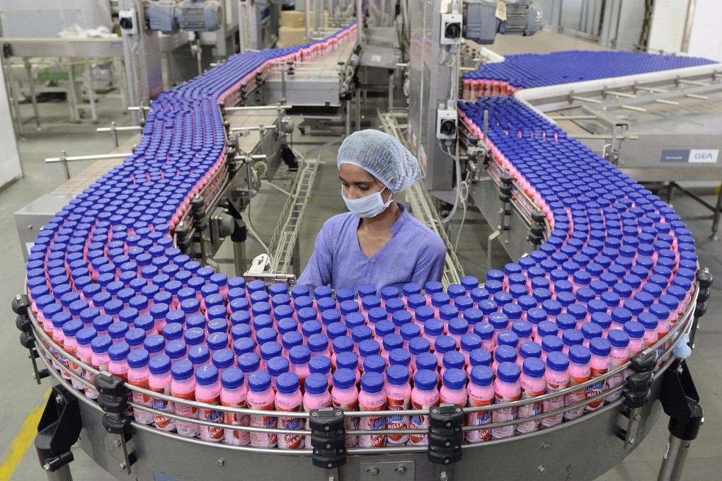 A worker at a bottle factory near Ahmedabad, India. Photo: AFP