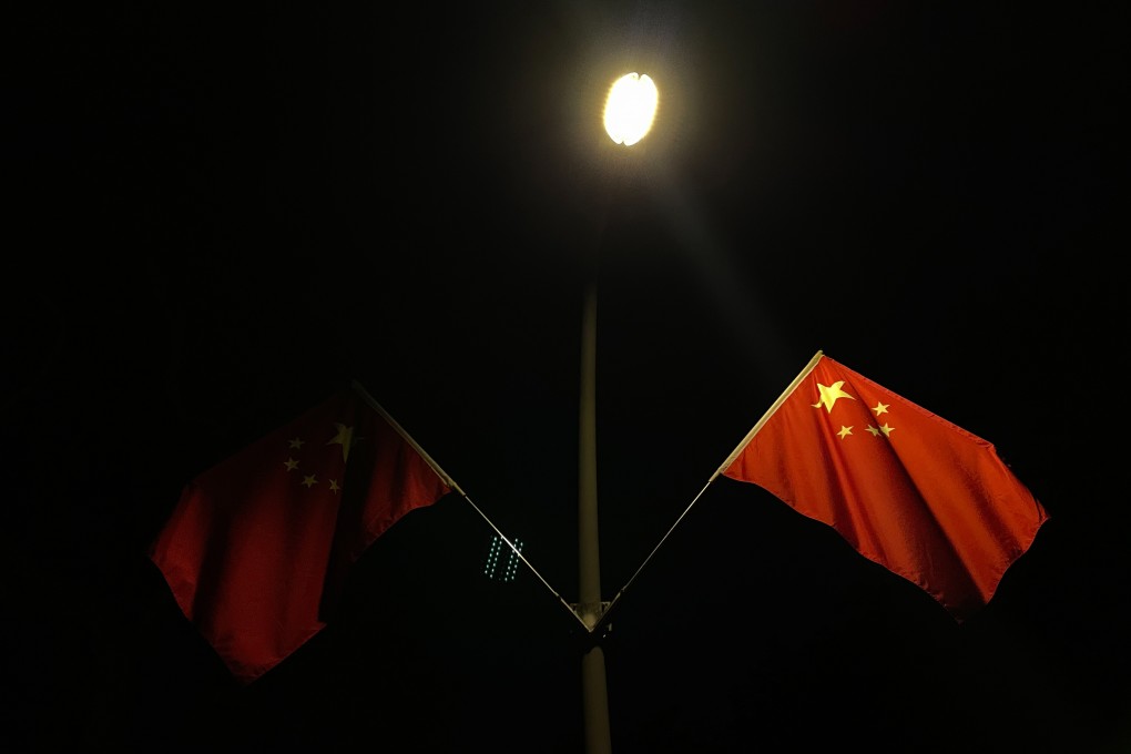 Chinese flags lit by street lamps at night in a park in Shenzhen on September 29. China will quickly overcome the power shortages, but developing a more resilient, sustainable energy sector will take time. Photo: Bloomberg