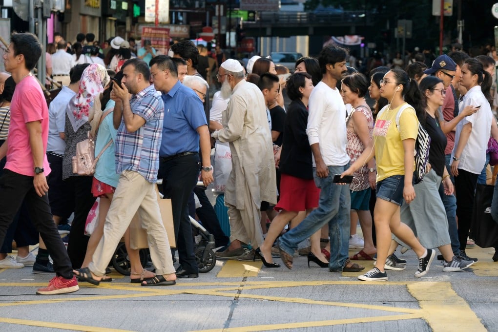 Pedestrians cross a road in Tsim Sha Tsui in 2018. Photo: Fung Chang