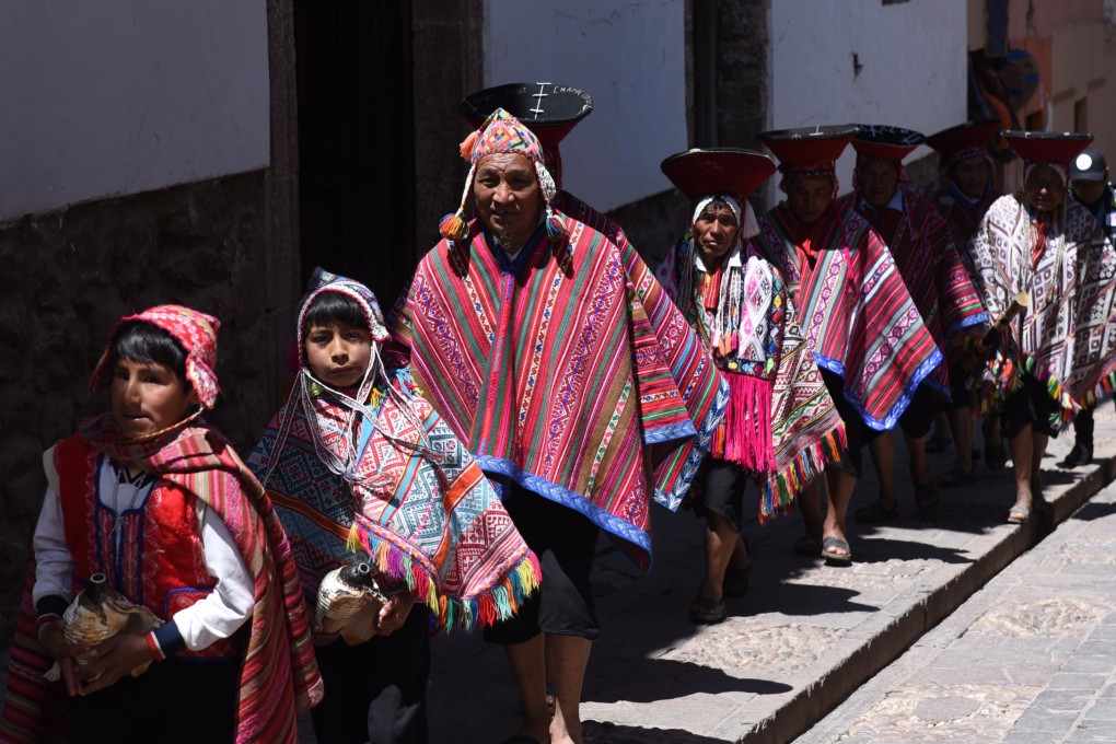 Wedding guests in traditional 
dress head to a church in 
Peru’s Sacred Valley of the Incas, where the ancient language of Quechua is spoken. It is one of the languages listed as in danger by Unesco that is undergoing a revival. Photo: Getty Images