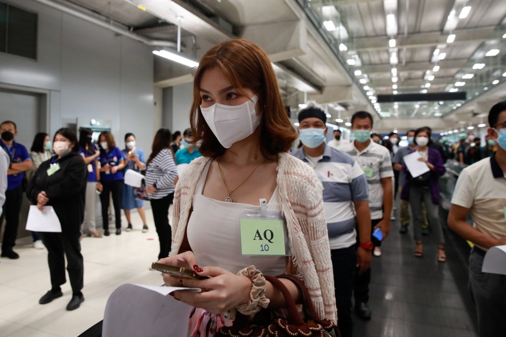 Volunteers queue up during a test of arrival procedures at Suvarnabhumi airport in Bangkok as Thailand prepares to reopen for vaccinated travellers from countries including China and Singapore on November 1. Photo: Reuters/Soe Zeya Tun