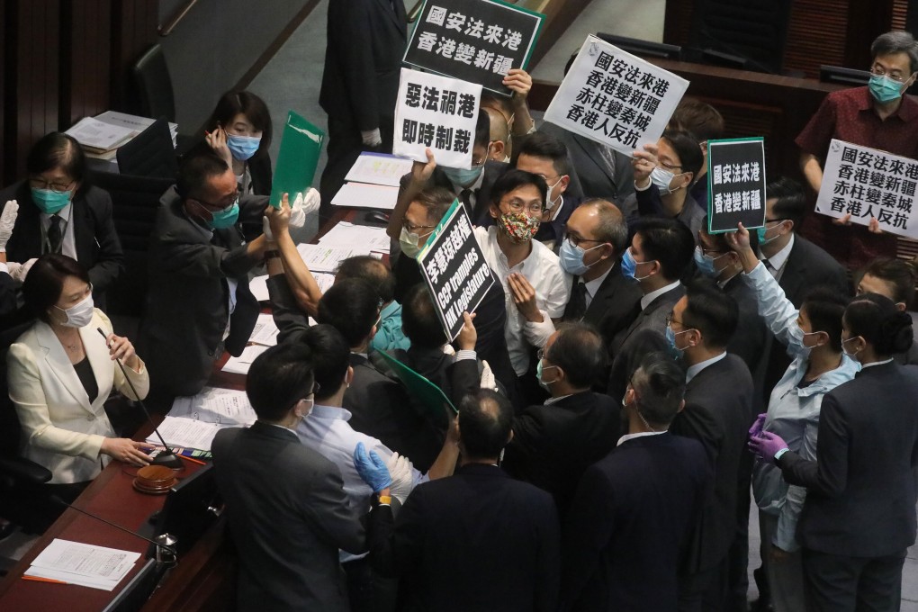 Chair Starry Lee (left, in white) attempts to continue a House Committee meeting over opposition protests at the Legislative Council complex in Tamar on May 22, 2020. Photo: Dickson Lee