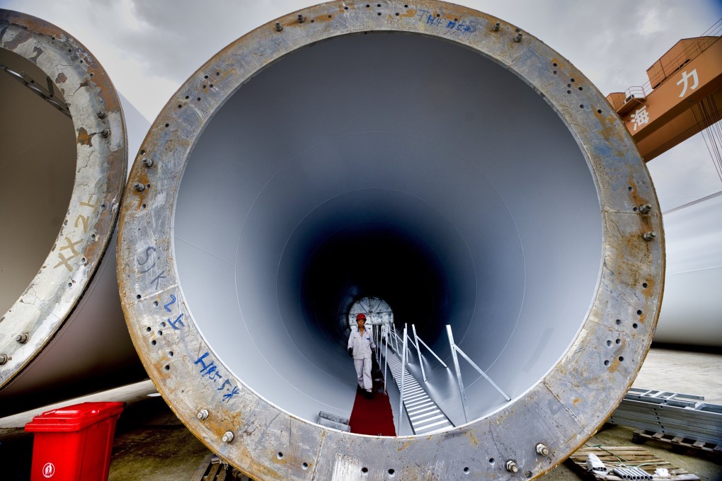 A man works on a wind turbine at the Jiangsu Haili Wind Power Equipment Technology Company during an organised media tour in Rudong, Jiangsu province, China, on September 15. Photo: EPA-EFE