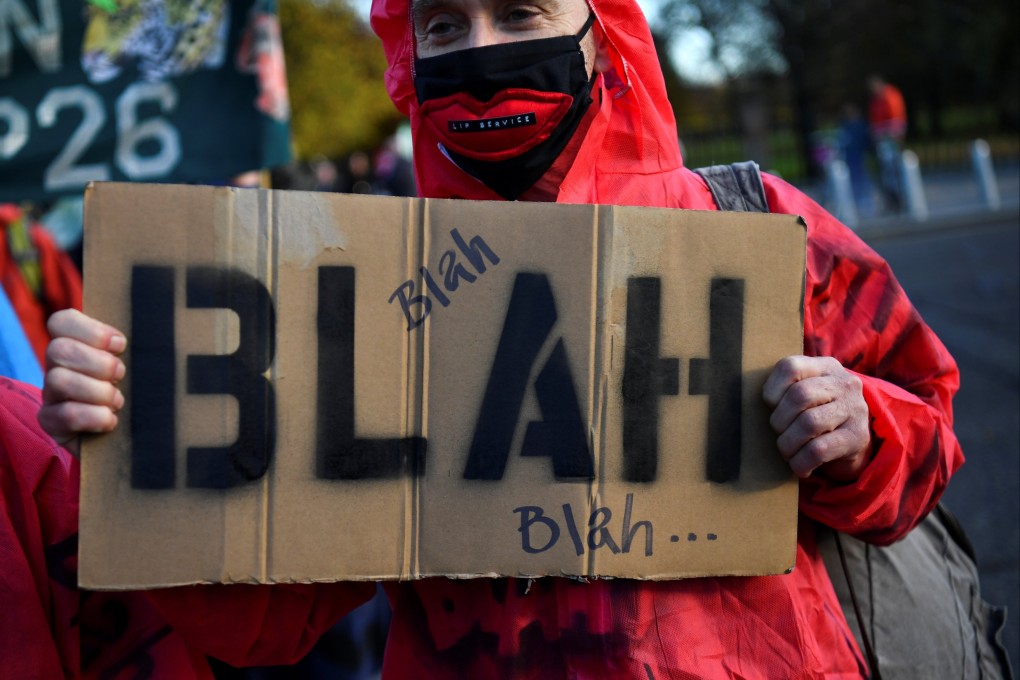 A protester holds a placard during a demonstration by climate activists ahead of the COP26 summit in Glasgow, Scotland, on October 30. Photo: Reuters