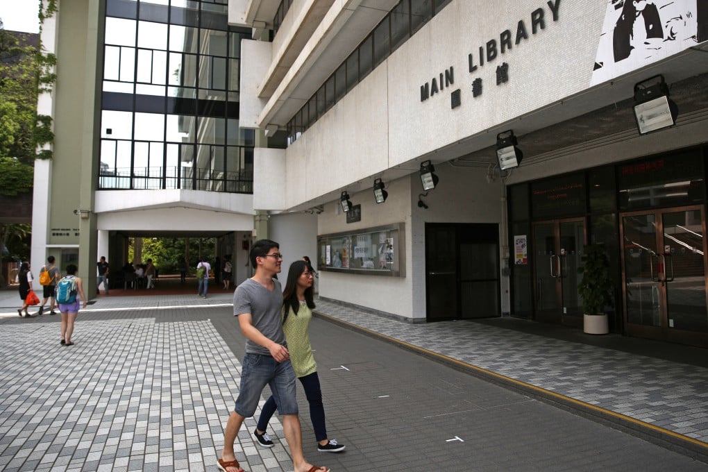 People walk past the HKU main library in Pok Fu Lam in May 2013. Photo: Sam Tsang