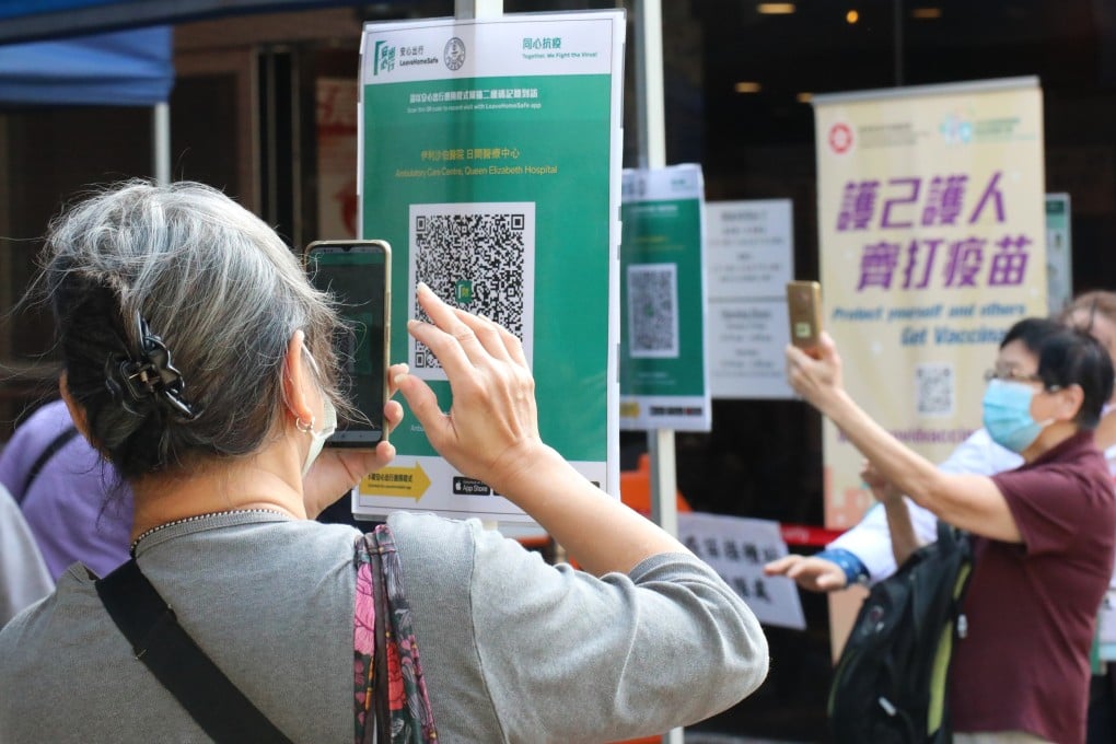 People use the Leave Home Safe app to enter Queen Elizabeth Hospital in Jordan on November 1, the day it became mandatory to use the app to enter government facilities. Photo: Felix Wong