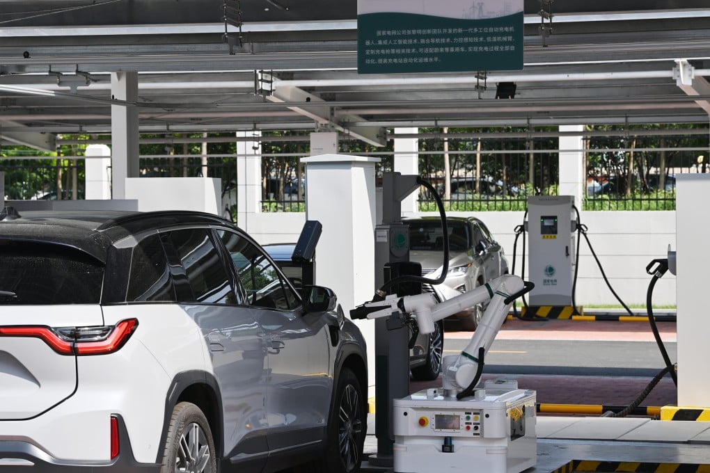 A charging robot for electric cars operates at the Jinmenhu New Energy Vehicle Integrated Service Centre in Tianjin on August 18. Chinese-made electric vehicles are poised to swamp international markets. Photo: Xinhua