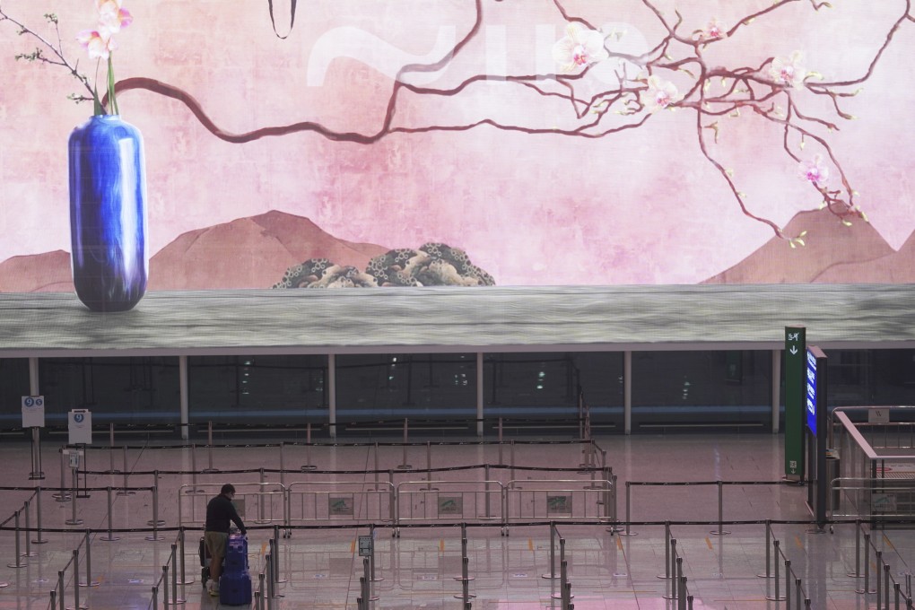 A lone passenger arrives at Hong Kong airport on November 2. Most arrivals to Hong Kong must undergo at least two weeks of quarantine in a government-designated hotel. Photo: Sam Tsang