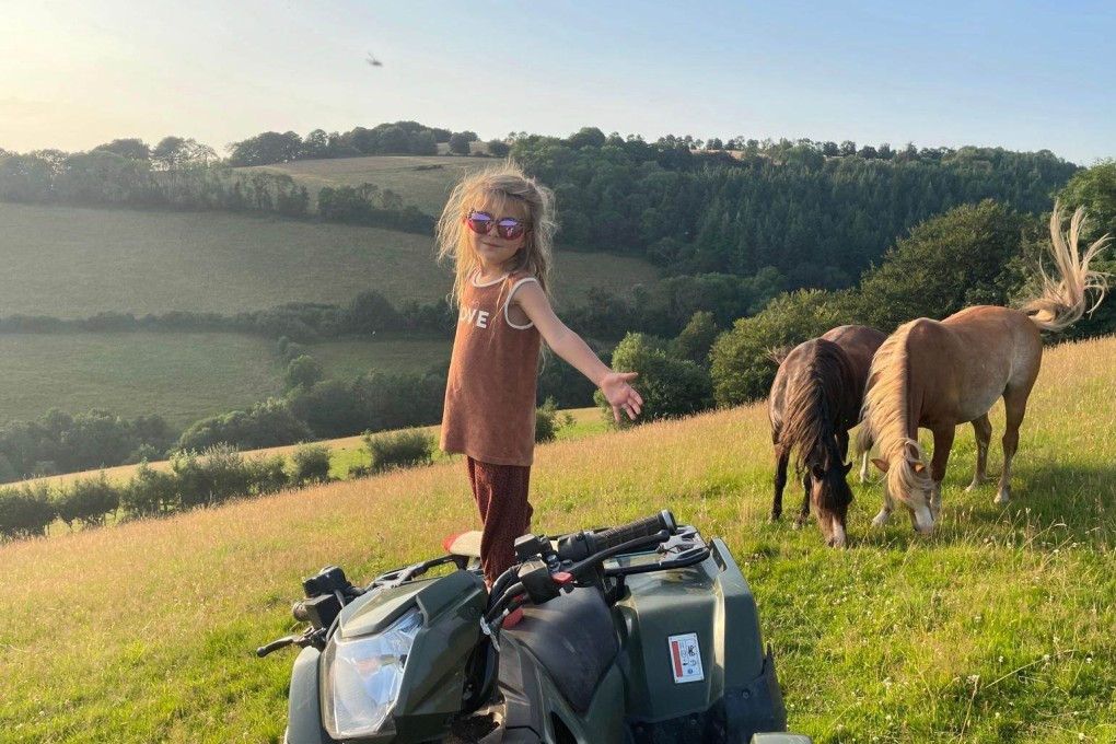Ben Horne and Yolanda Cruwys’s four-year-old daughter at their Cove Down Farm in Devon, England. The couple built six “low-impact” solar-panelled cabins on their land, priced nightly at around US$270.
