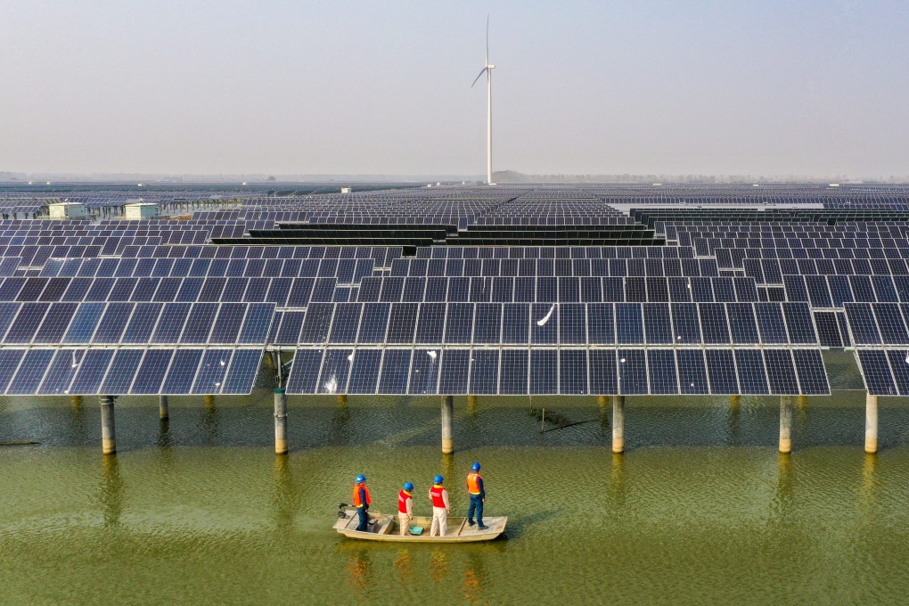 Electricity workers patrol a solar and wind power farm in Sheyanghu, Baoying county, in Jiangsu province, on November 3. Photo: Xinhua