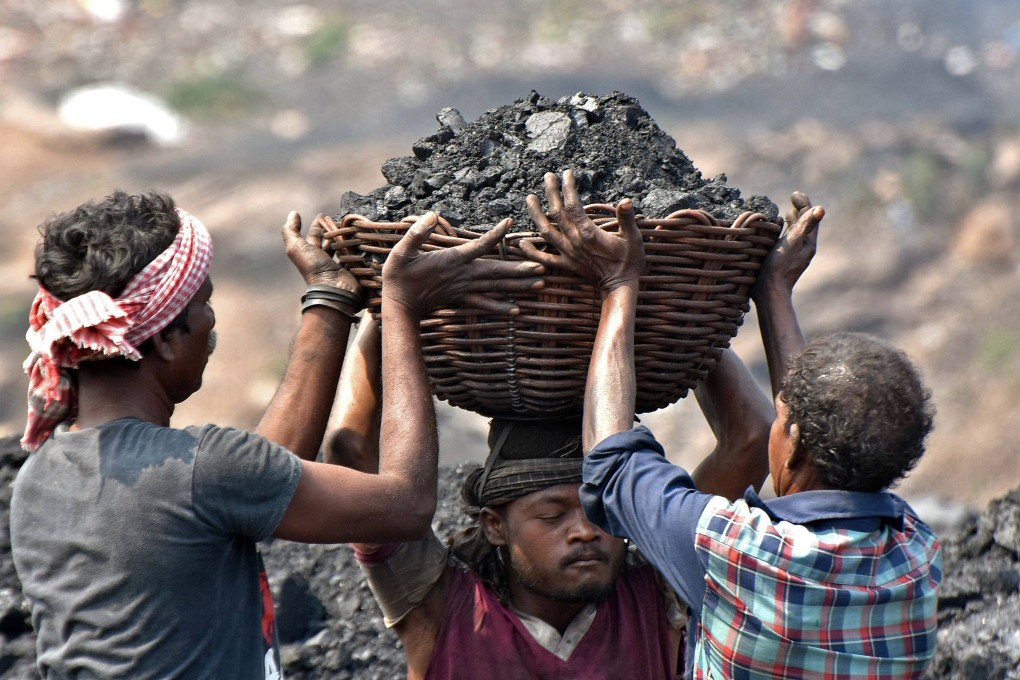 Workers prepare to load coal onto a truck at the Jharia coalfield in Dhanbad, in India’s Jharkhand state, on October 14. India has one of the world’s largest reserves of coal and is the second-largest importer of the fossil fuel, yet it is in crisis. Photo: AFP
