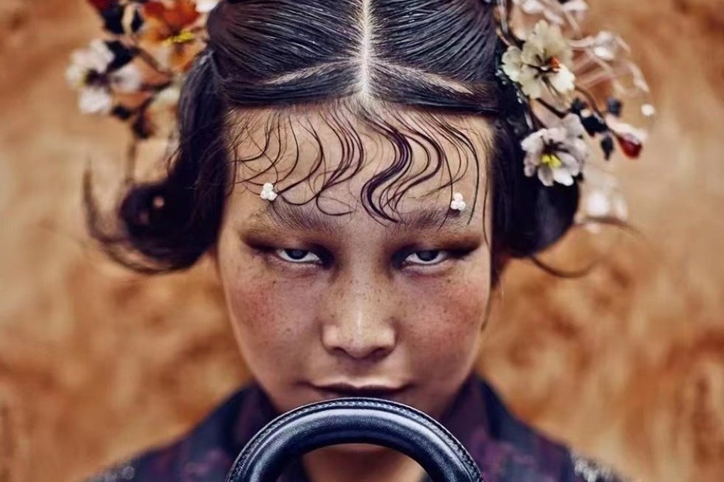 The photo by Chinese photographer Chen Man that Dior has removed from display, showing a woman in traditional Chinese costume holding a Lady Dior bag.