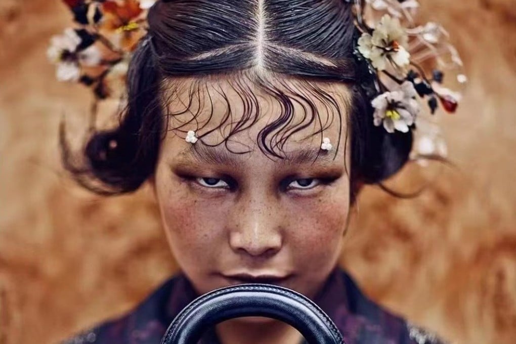 The photo by Chinese photographer Chen Man that Dior has removed from display, showing a woman in traditional Chinese costume holding a Lady Dior bag.