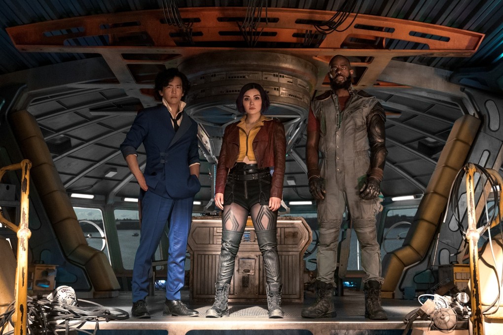 (From left) John Cho as Spike Spiegel, Daniella Pineda as Faye Valentine, and Mustafa Shakir as Jet Black in a still from Cowboy Bebop. Photo: Geoffrey Short/Netflix
