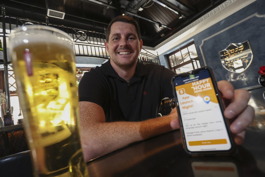 Mark Sinclair shows the Happy Hour Hong Kong app he founded. It has a directory of more than 400 bars, covering most districts. Photo: May Tse