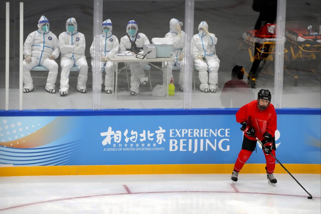 Medical personnel in protective suits watch as the China Ice Sports College hockey team practices during the Experience Beijing ice hockey domestic test activity, a test event for the 2022 Beijing Winter Olympics, at the National Indoor Stadium in Beijing, on November 10. Photo: AP