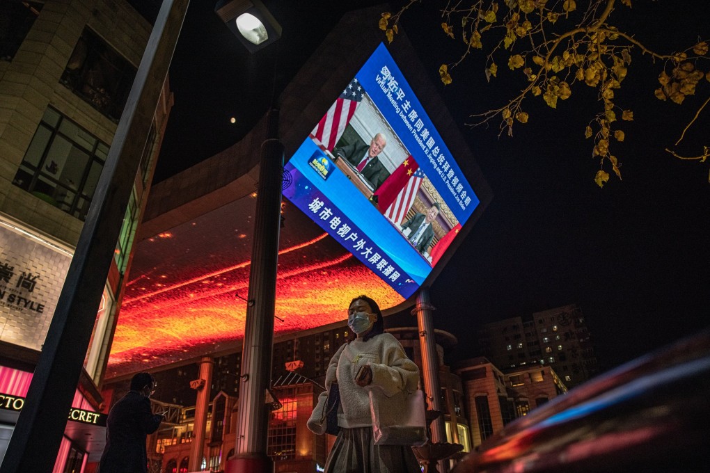 People walk past a big screen in Beijing showing the virtual summit between US President Joe Biden and Chinese President Xi Jinping on November 16. The meeting came as both leaders try to reinvigorate flagging economic growth in their respective countries. Photo: EPA-EFE