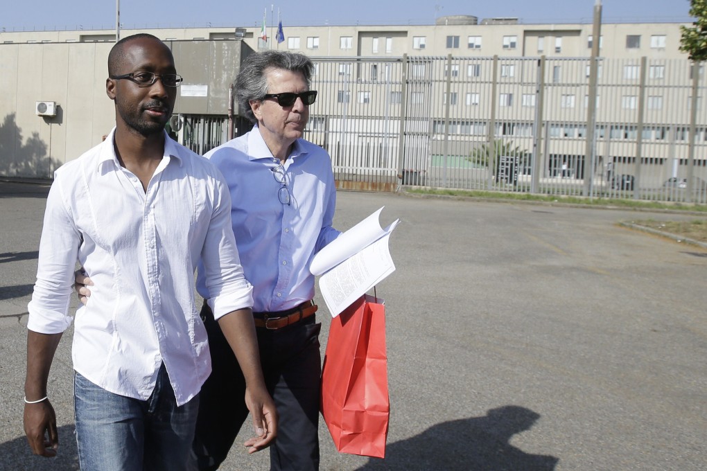 Rudy Guede, left, on a 36-hour release from prison in Italy in 2016. Guede, the only person convicted in the 2007 murder of British student Meredith Kercher has now been freed after serving most of his 16-year prison sentence. His planned January 2022 release was moved up a few weeks by a judge. Photo: AP
