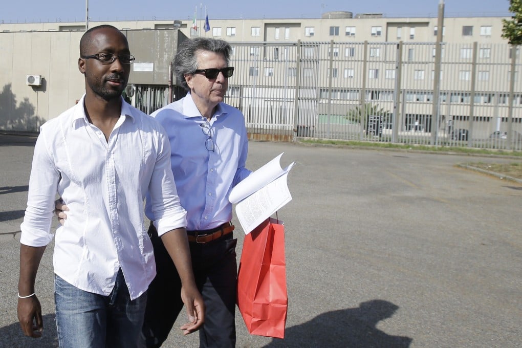 Rudy Guede, left, on a 36-hour release from prison in Italy in 2016. Guede, the only person convicted in the 2007 murder of British student Meredith Kercher has now been freed after serving most of his 16-year prison sentence. His planned January 2022 release was moved up a few weeks by a judge. Photo: AP
