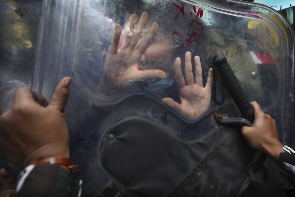 Security officers push back protesters supporting farmers’ agitation against agricultural reforms in New Delhi on February 3. Photo: AP