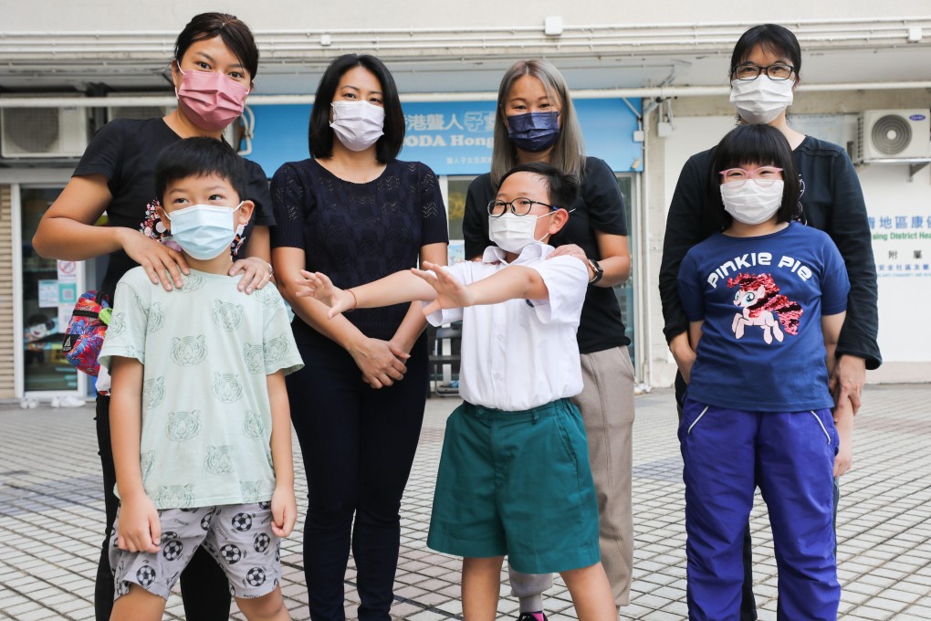 Cindy Chan (back row, second left) poses with beneficiaries outside the offices of the organisation she founded, CODA Hong Kong. Photo: Xiaomei Chen