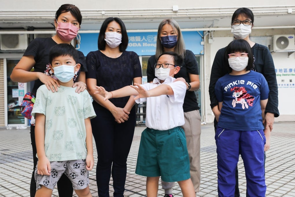 Cindy Chan (back row, second left) poses with beneficiaries outside the offices of the organisation she founded, CODA Hong Kong. Photo: Xiaomei Chen
