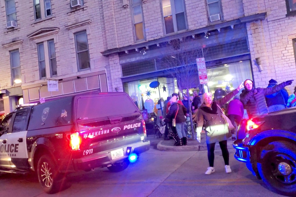 People gesture as they speak to a police officer after a car plowed through a crowd at a holiday parade in Waukesha, Wisconsin, on Sunday. Photo: Jordan Woynilko via Reuters