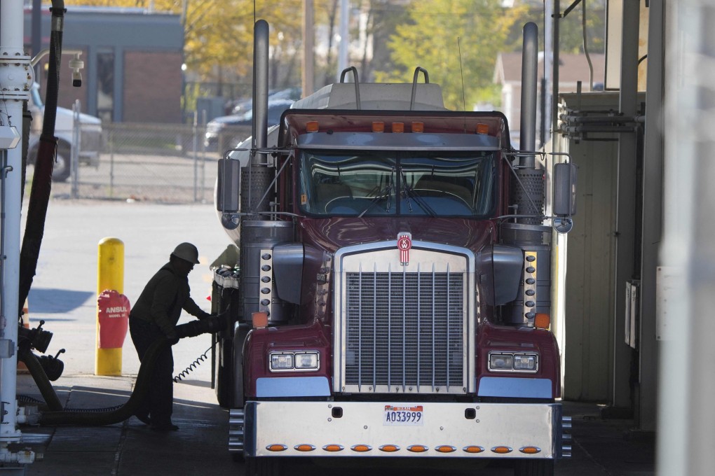 A trucker puts fuel into his truck in Salt Lake City, Utah. US President Joe Biden has  ordered the release of 50 million barrels of oil from US strategic reserves in a coordinated attempt with other countries to tamp down soaring fuel prices. Photo: AFP