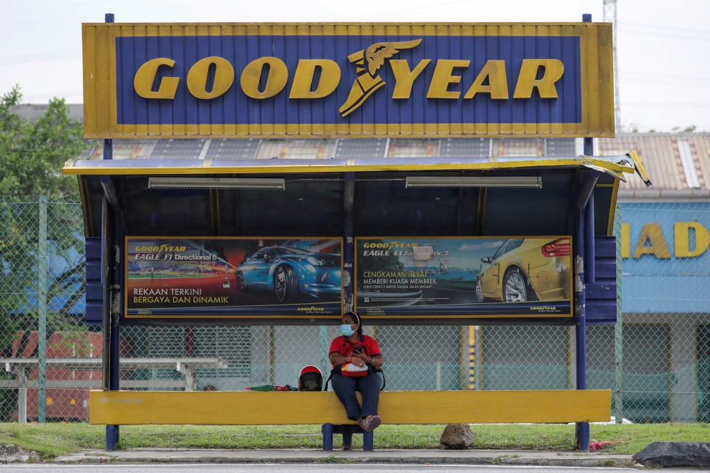 A person sits at a bus stop outside a Goodyear factory in Shah Alam, Malaysia. File photo: Reuters