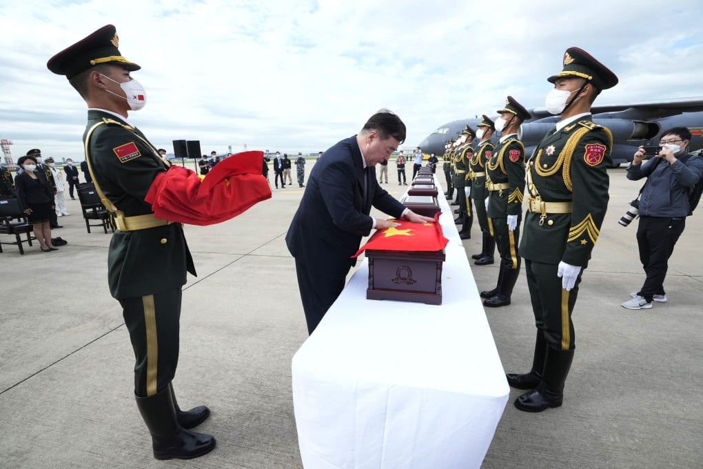 Xing Haiming, China’s ambassador to South Korea, covers a casket containing the remains of a Chinese soldier with a flag during a ceremony at the Incheon airport in September. The remains of 109 Chinese soldiers who died during the Korean war were returned. Photo: Getty Images