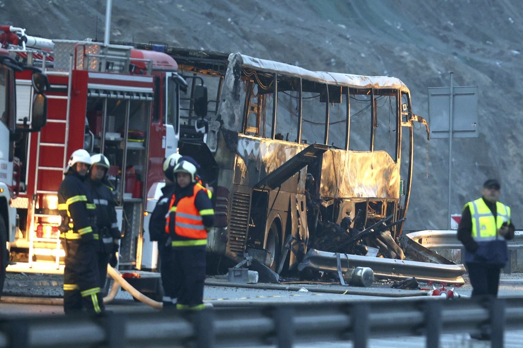 Firefighters and forensic workers inspect the scene of a bus crash which the authorities say killed at least 45 people on a highway in western Bulgaria on Tuesday. The bus, registered in Northern Macedonia, crashed around 2 am and there were children among the victims. Photo: BTA Agency Bulgaria via AP