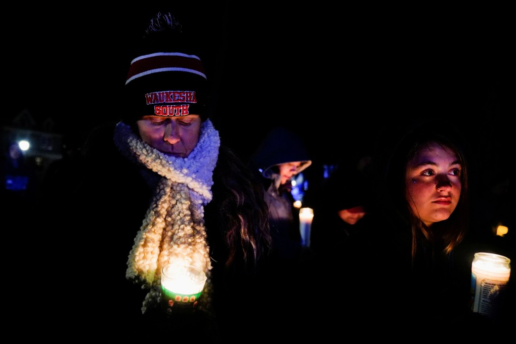 Community members mourn during a candle light vigil in Cutler Park on Monday after a car plowed through a holiday parade in Waukesha, Wisconsin. Photo: Reuters