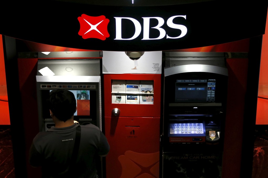 A person uses a DBS ATM machine in Singapore. Photo: Reuters