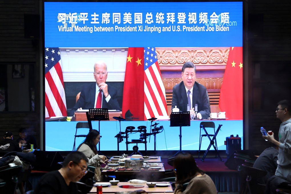 A screen at a Beijing restaurant shows Chinese President Xi Jinping attending a virtual meeting with US President Joe Biden via video link. Photo: Reuters
