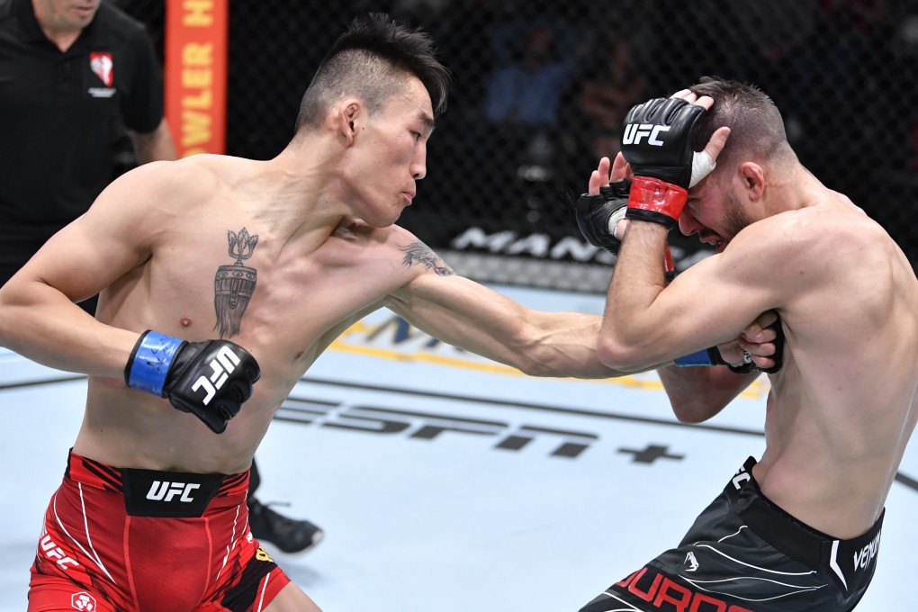 Aori Qileng of China punches Cody Durden in their flyweight fight at UFC Vegas 43. Photos: Chris Unger/Zuffa LLC