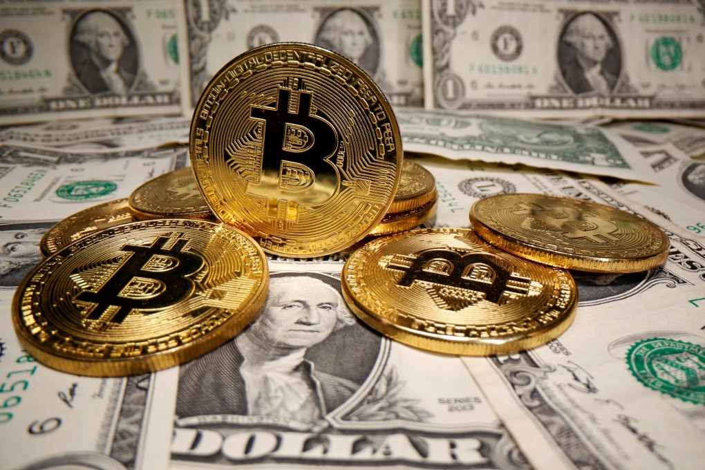 Representations of virtual currency bitcoin placed on US dollar banknotes on May 26, 2020. Photo: Reuters