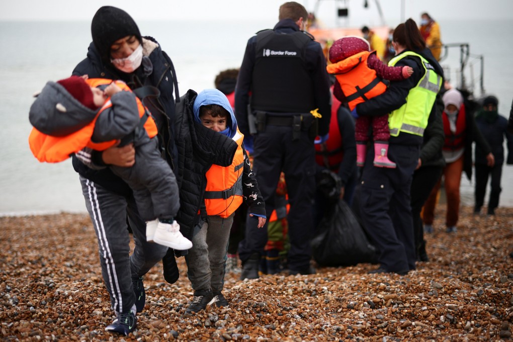 Migrants were brought ashore  in Dungeness, Britain by a RNLI lifeboat after crossing the Channel on Wednesday. Photo: Reuters