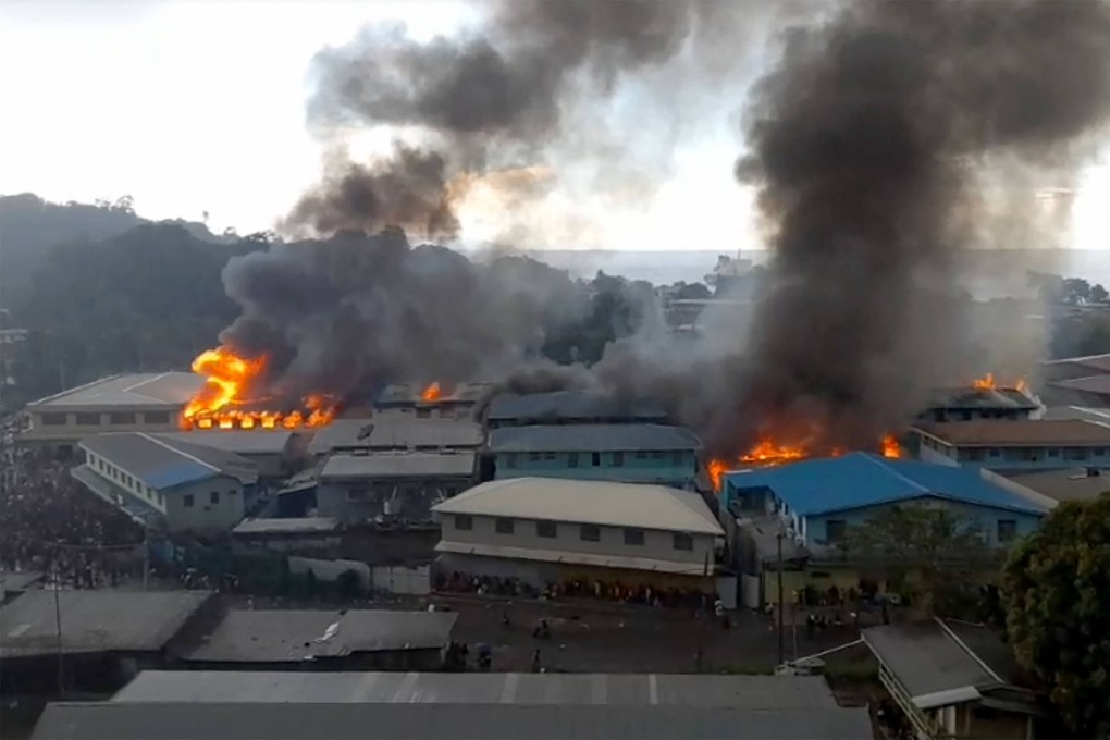 Rioters torched buildings in the Chinatown district in Honiara on Thursday. Photo: ZFM Radio/AFP