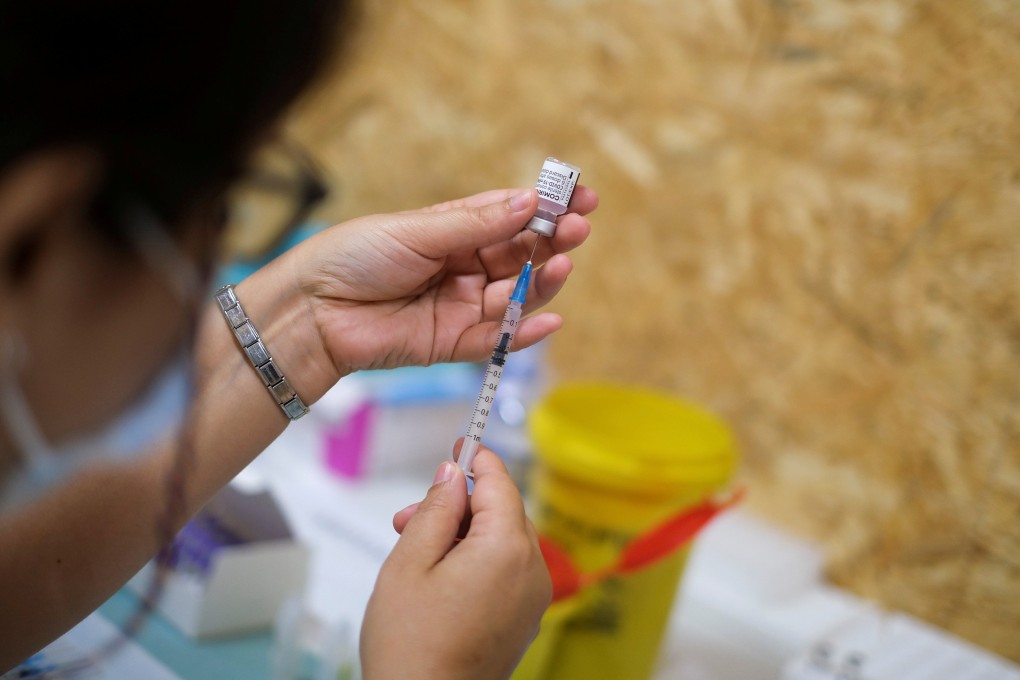 A health worker prepares a dose of the Pfizer Covid-19 vaccine in Seixal, Portugal. Photo: Reuters