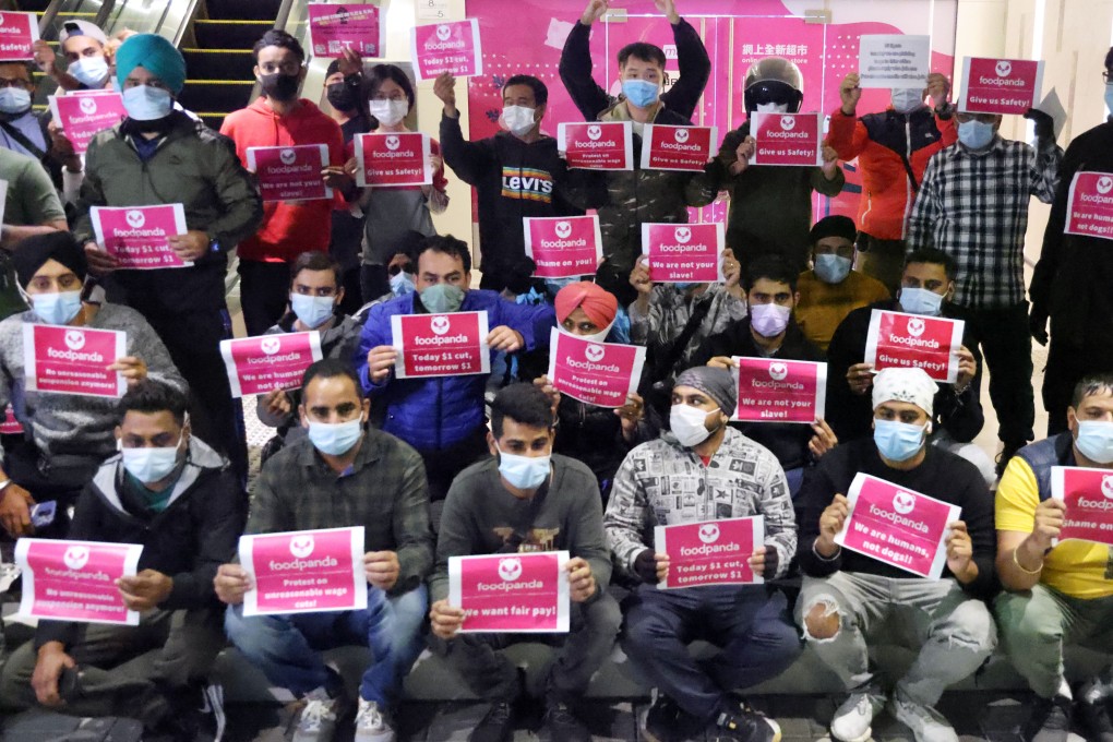Foodpanda workers hold up protest slogans. Photo: May Tae