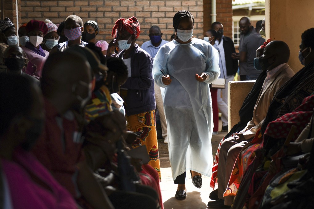 Numbers are handed out to people waiting to receive the AstraZeneca Covid -19 vaccine at a health centre in Blantyre, Malawi, on March 29. More than 90 per cent of Africa’s population has yet to be fully vaccinated against Covid-19. Photo: AP