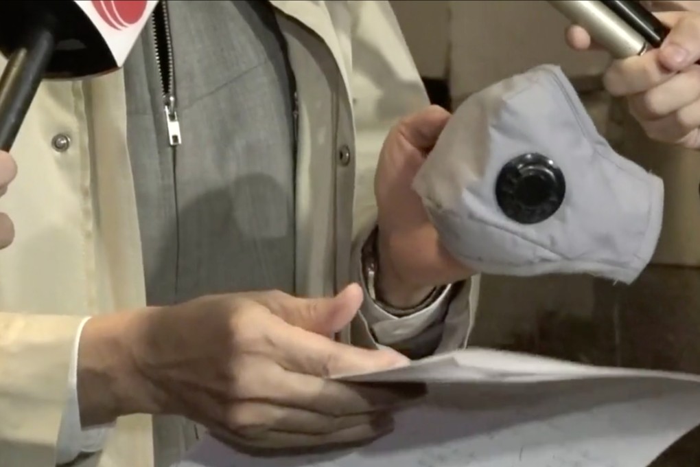 Yuen Kwok-yung holds a mask with air valves to protect against Covid-19. Photo: RTHK