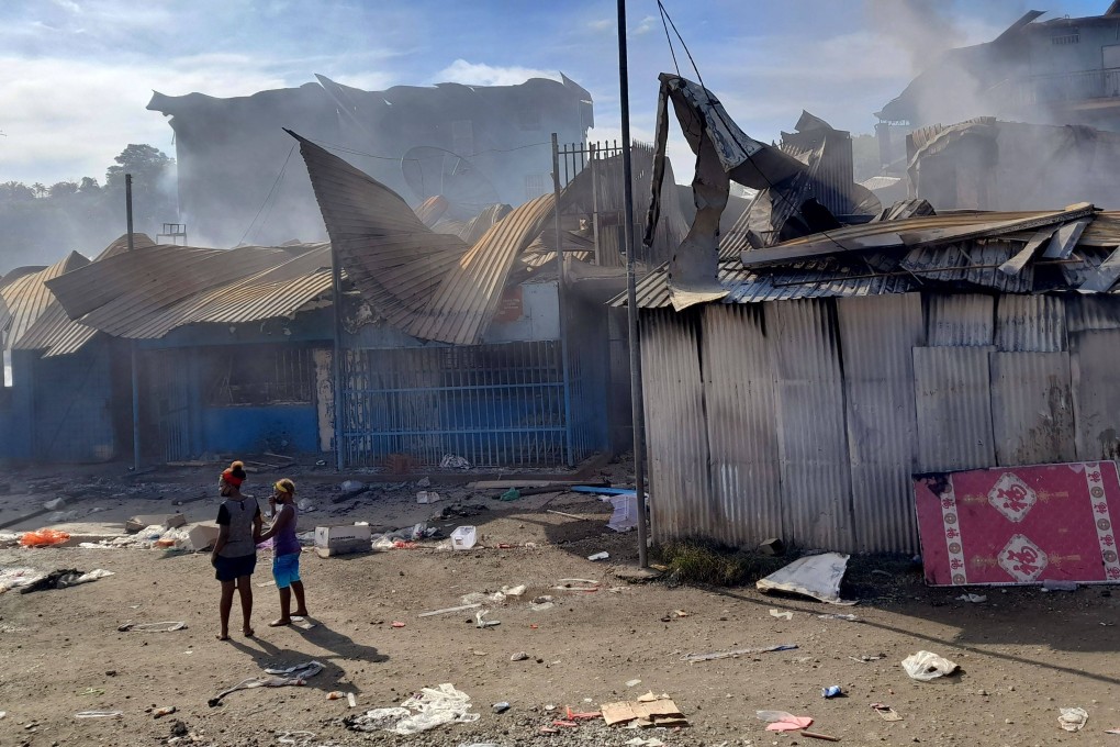 Smoke rises from a burnt out buildings in Honiara’s Chinatown on Friday after two days of rioting. Photo: AFP