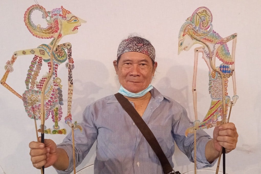 Ki Samidjan posing with his shadow puppets Betari Jaluwati, left, and Warya Bissunanda. Photo: Handout