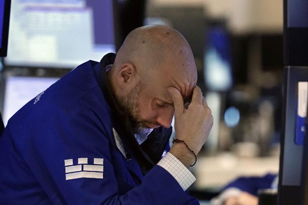 Specialist Meric Greenbaum works at his post on the floor of the New York Stock Exchange on Friday. Photo: AP