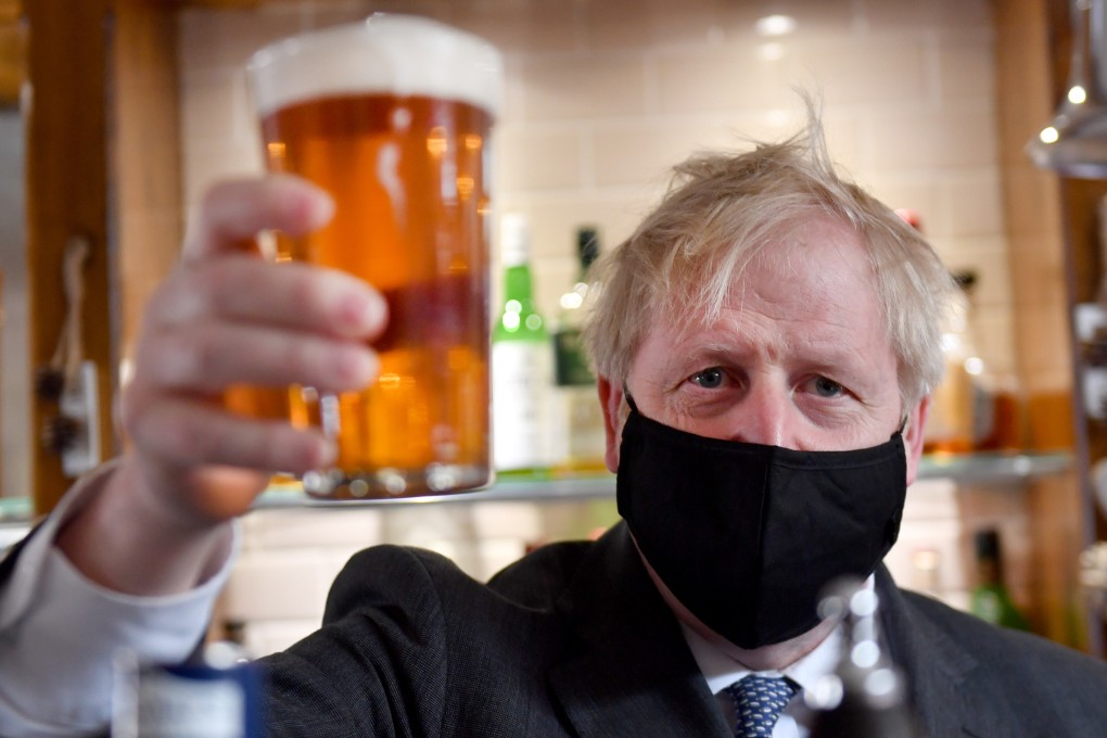 British Prime Minister Boris Johnson holding a pint of beer. Photo: Jacob King/PA Wire/dpa