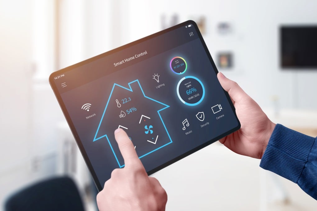 A person uses an all-in-one smart home control system. Photo: Shutterstock